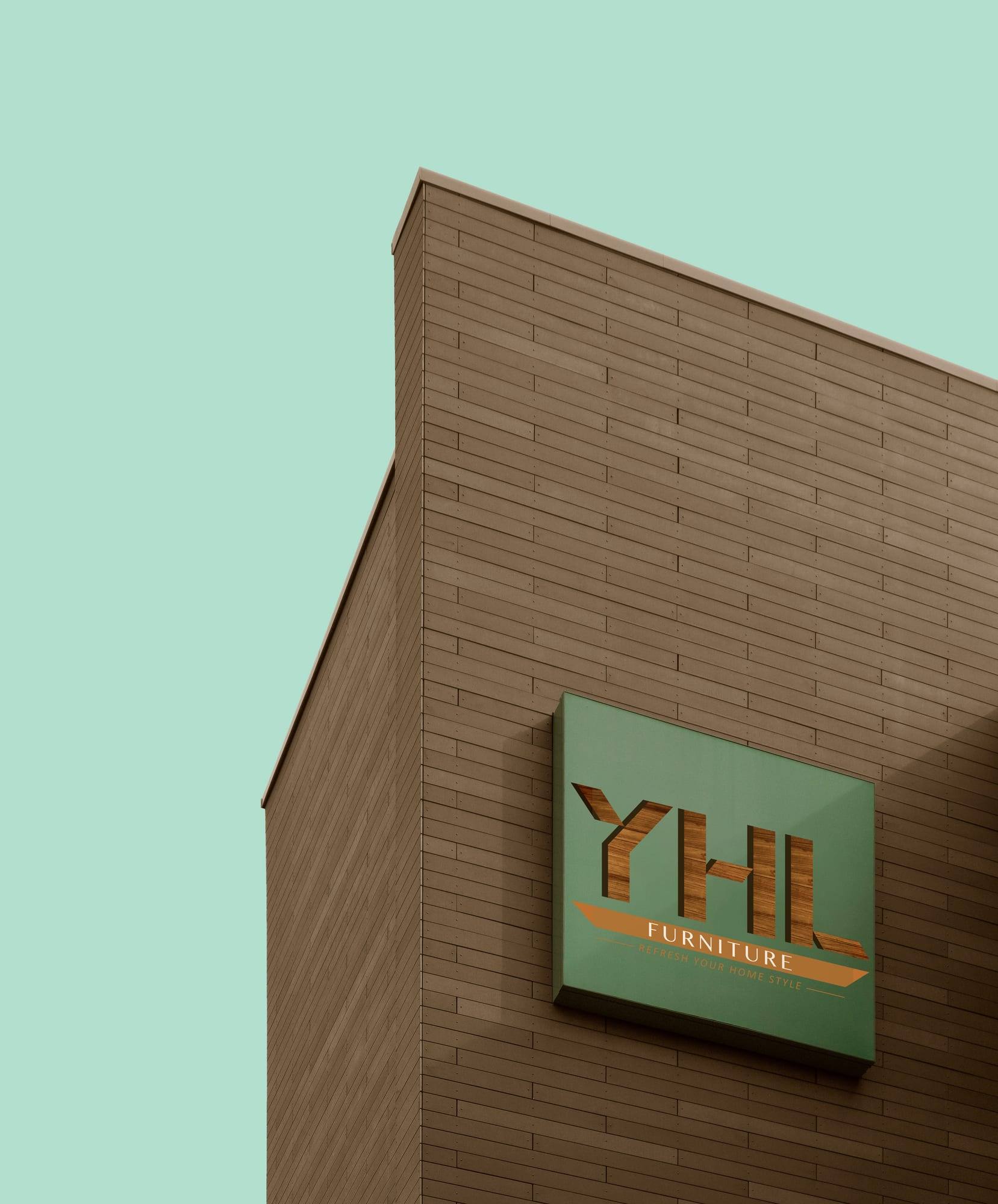 YHL Furniture logo on a square green sign on the side of a brick building