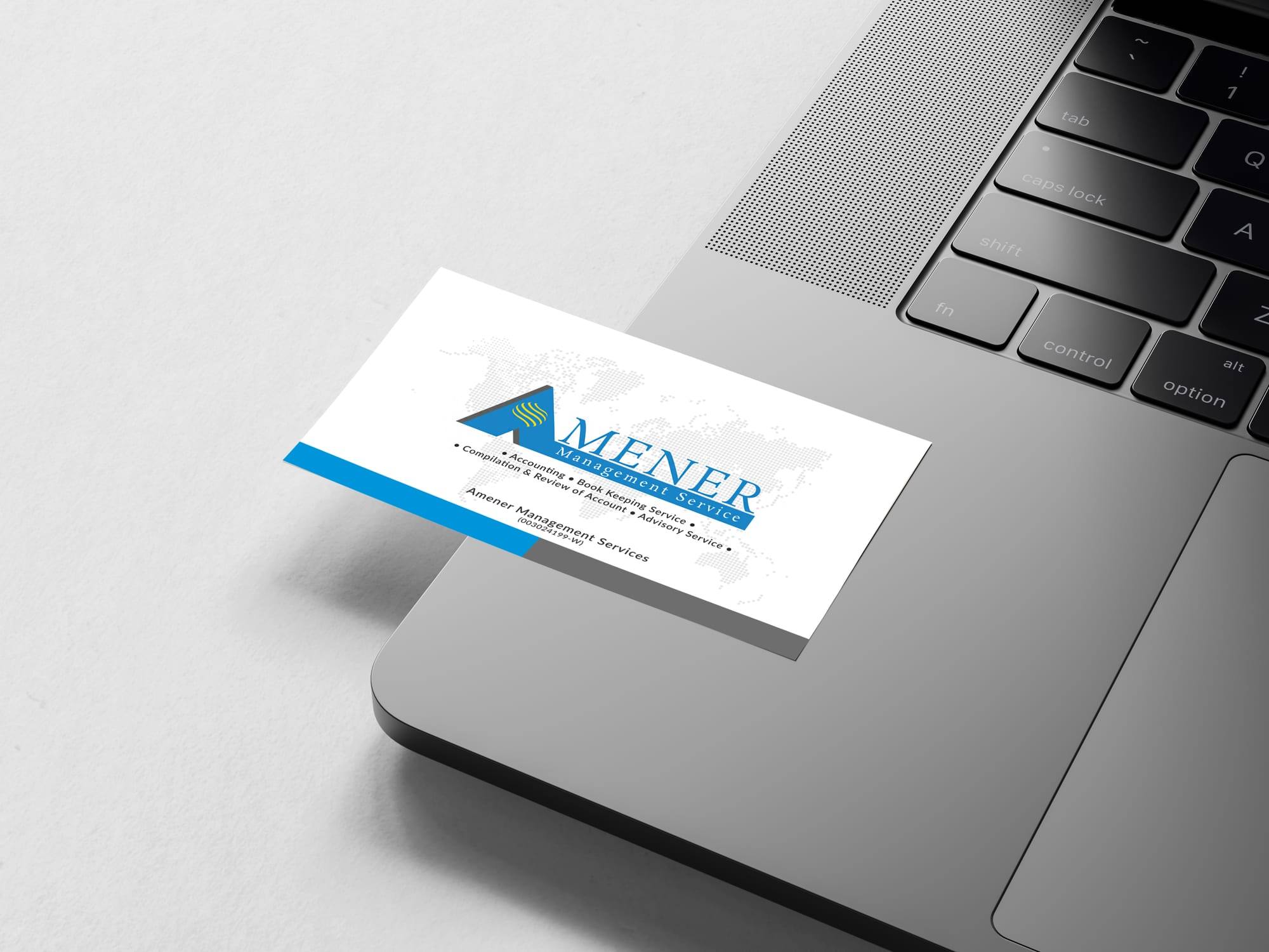 An Amener Management Services name card resting on a laptop