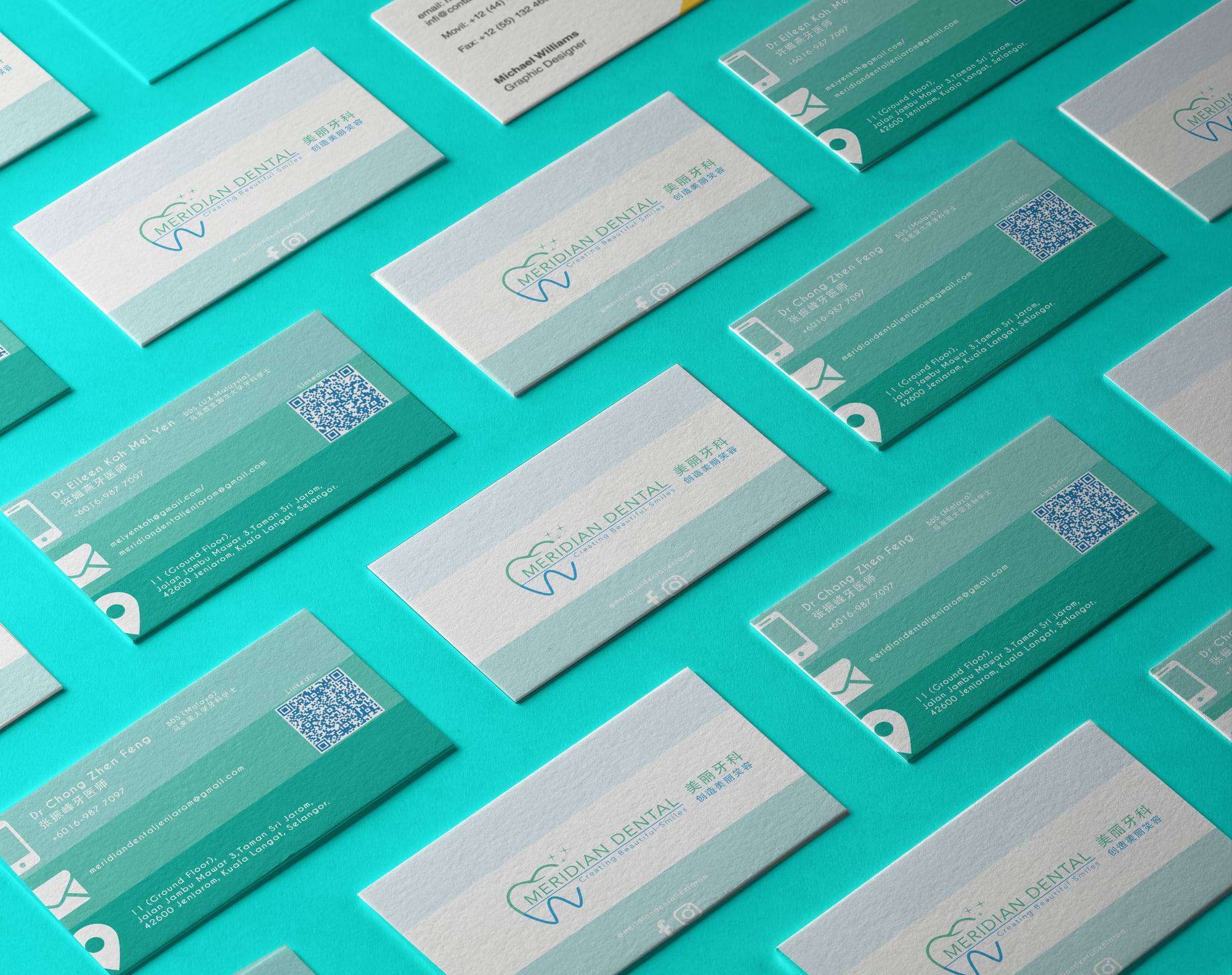 Rows of Meridian Dental name cards in white and teal on a turquoise surface