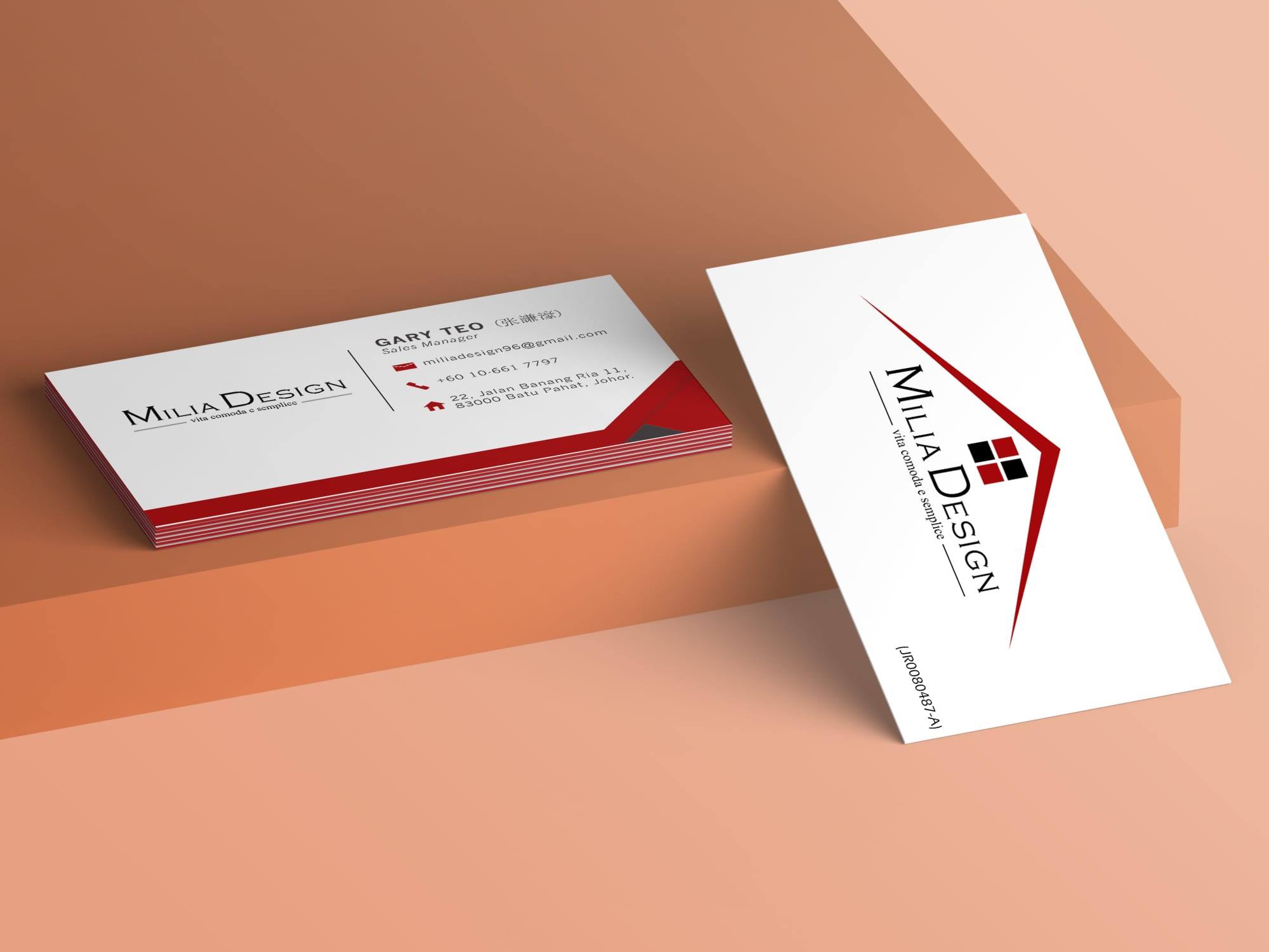 Milia Design name cards in white and red on a peach-coloured step