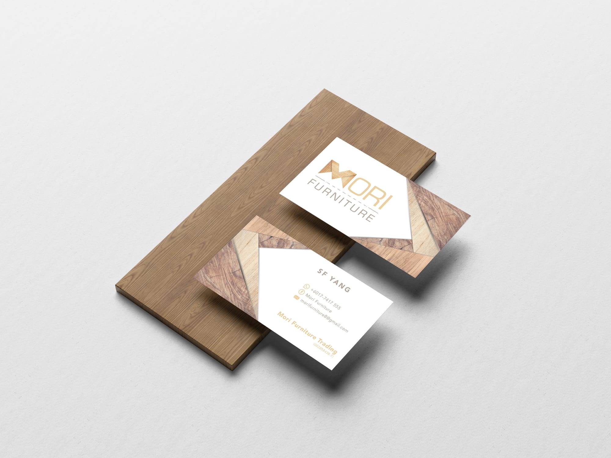 Front and back of Mori Furniture name cards on a wooden board
