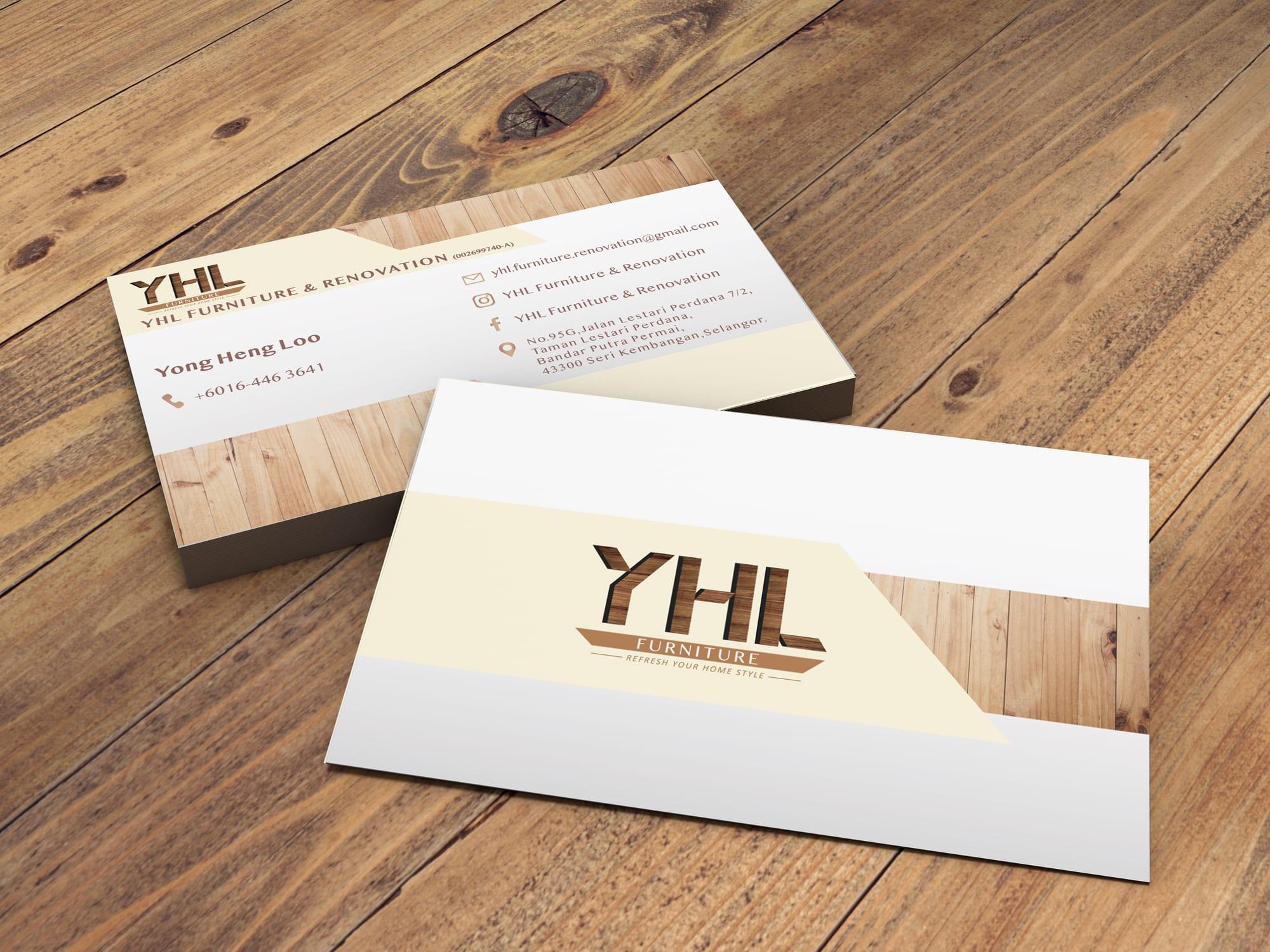 Front and back of YHL Furniture and Renovation name cards on a wooden table